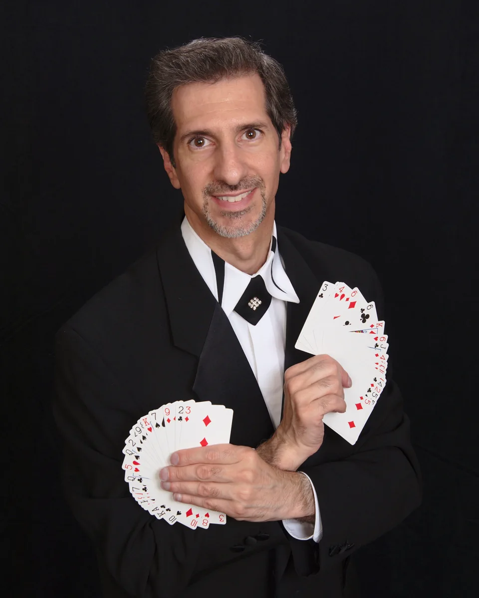 Tony Spero holding two fans of playing cards
